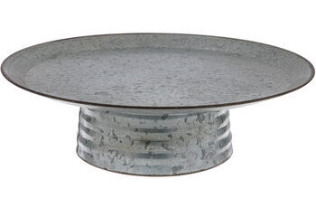 Artfully display your perfectly polished confection on Galvanized Metal Cake Stand. Made of galvanized metal with a round, flared top, this stand will liven up birthday parties, weddings, and your very own kitchen. Place your cake on a cake board, and place the whole piece on top of this stand for a sweet, edible centerpiece. Serve up!

Base Diameter: 7 5/16"
Top Diameter: 13 7/8"
Height: 4 1/4"